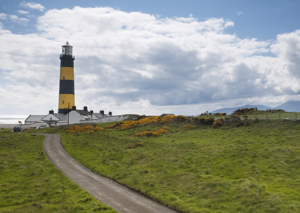 Wide shot of the striped lighthouse tower at St. John's Point, Co. Down